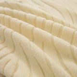 Macro of the cream beige jacquard weave, showing its soft raised wavy stripes