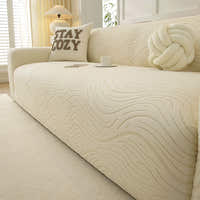 Cream beige jacquard sofa cover in a sunlit room with a table lamp, cozy cushion and teacup