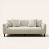 Cream ivory jacquard sofa cover on a three-seater, front view on ivory backdrop with matching cushions