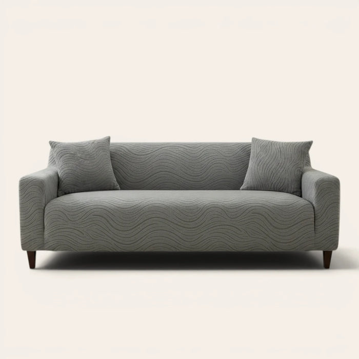 Mist grey jacquard sofa cover on a three-seater, front view on ivory backdrop with two matching cushions