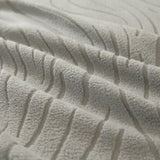 Macro of the mist grey jacquard weave, showing its soft raised wavy stripes