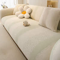 Top angled view of the cream sage striped jacquard sofa cover with a flower cushion and teacup on the seat
