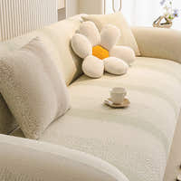 Corner view of the cream sage striped jacquard cover fitted on an L-shaped sofa with a flower cushion