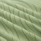 Macro of the sage green jacquard weave, showing its soft raised wavy stripes