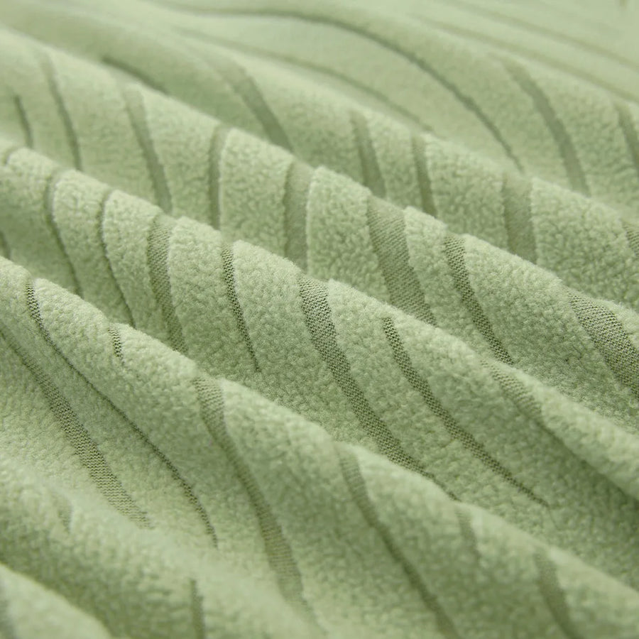 Macro of the sage green jacquard weave, showing its soft raised wavy stripes