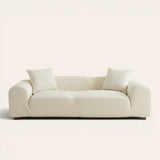 Sand linen jacquard sofa cover fitted on a three-seater, front view on ivory backdrop with two matching cushions