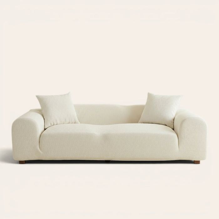 Sand linen jacquard sofa cover fitted on a three-seater, front view on ivory backdrop with two matching cushions