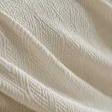 Macro close-up of the sand linen jacquard weave, showing its soft textured pattern and gentle folds