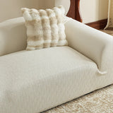 Corner view of the sand linen jacquard sofa cover, snug seat and armrest with a soft faux fur cushion
