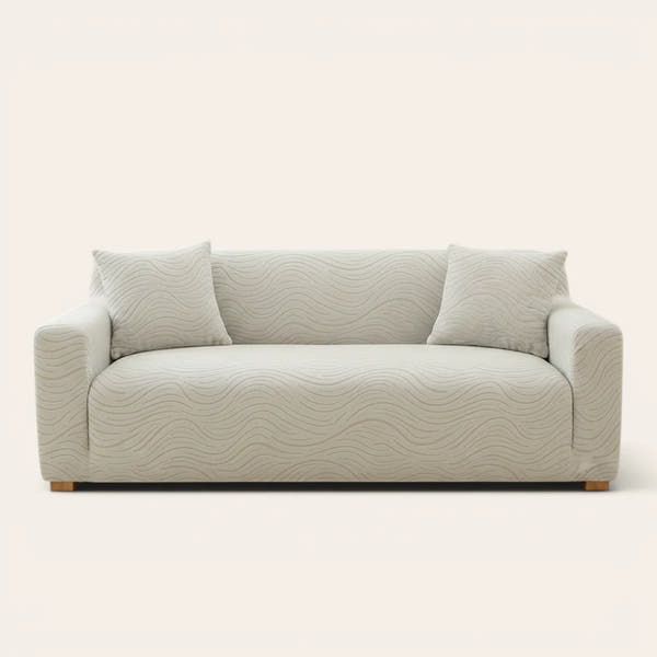 Soft ivory jacquard sofa cover fitted on a three-seater with wave pattern, front view on ivory backdrop