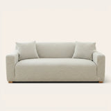 Soft ivory jacquard sofa cover fitted on a three-seater with wave pattern, front view on ivory backdrop