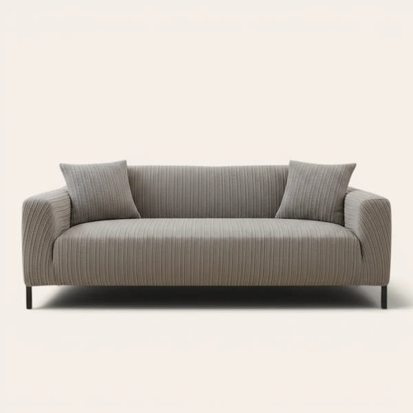 Charcoal ribbed knit sofa cover fitted on a three-seat couch with cushions, front view on ivory.