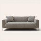 Charcoal ribbed knit sofa cover fitted on a three-seat couch with cushions, front view on ivory.