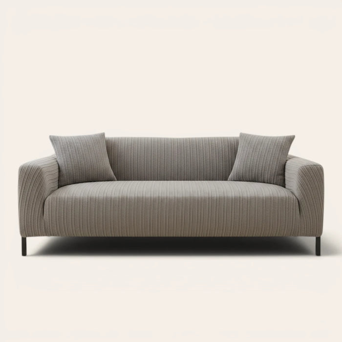 Charcoal ribbed knit sofa cover fitted on a three-seat couch with cushions, front view on ivory.