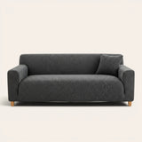 Charcoal knit sofa cover fitted on a three-seater, front view on ivory backdrop