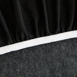 Detail of the elastic hem edge and white piping on the charcoal knit stretch cover