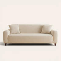 Cream beige knit sofa cover fitted on a three-seater, front view on ivory backdrop