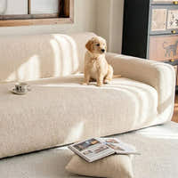 Cream beige knit sofa cover in a sunlit room with a golden puppy resting on the seat