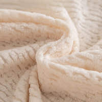 Macro of plush cream beige knit fabric showing fleece texture and fine striping
