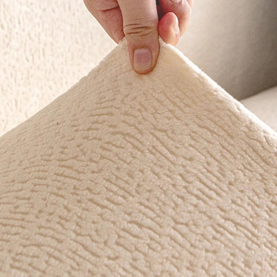 Detail of the cream beige knit fabric held up to reveal its soft fleece surface