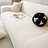 Close-up of cream ivory knit sofa cover seat with striped texture and decorative cushion