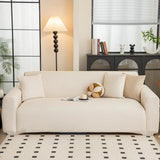 Cream linen knit sofa cover styled in a bright living room with floor lamp and patterned rug
