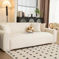 Angled view of cream linen knit sofa cover in a bright lounge with black cabinet and rug