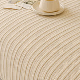 Macro of honey taupe knit fabric showing vertical ribbed texture and flowing folds