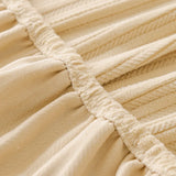 Detail of the elastic seam and gathered edge on the honey taupe knit stretch cover