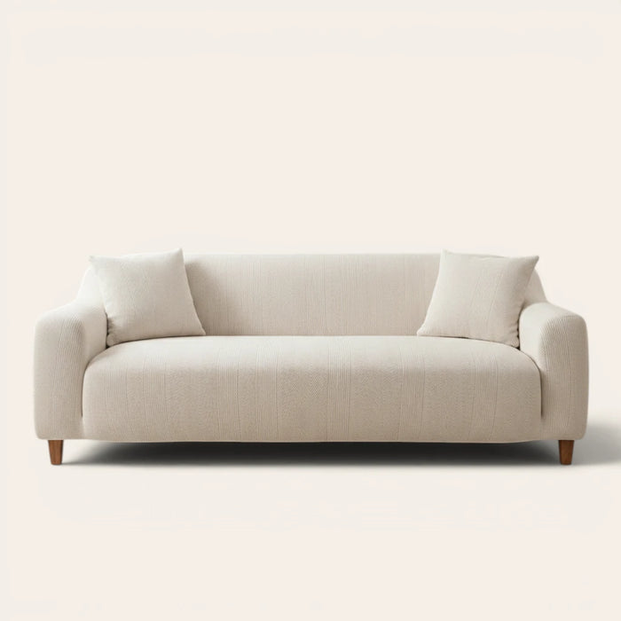 Ivory sand knit sofa cover fitted on a three-seater, front view on ivory backdrop