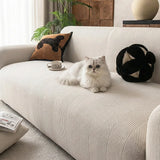 Ivory sand knit sofa cover in a bright room with a white cat resting on the seat