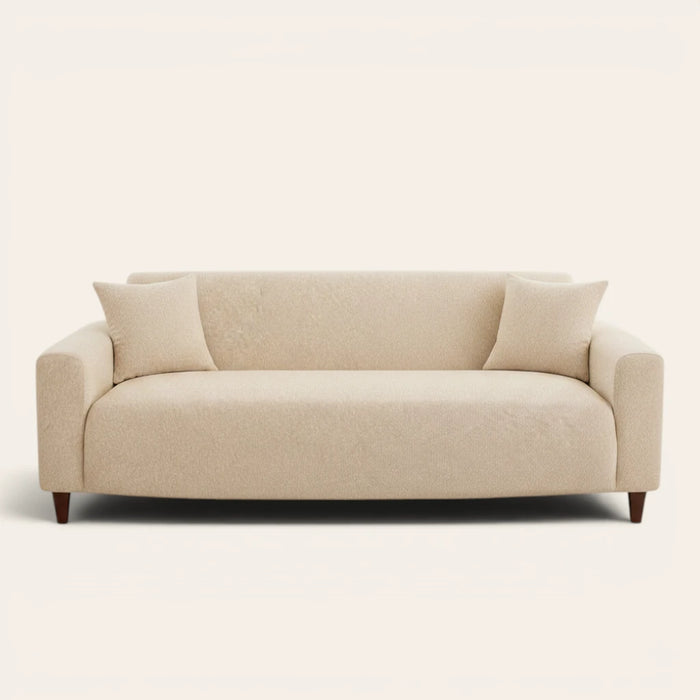 Sand beige knit sofa cover fitted on a three-seat couch with matching cushions, front view on ivory.