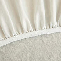 Detail of the elastic hem edge on the silver grey knit stretch sofa cover
