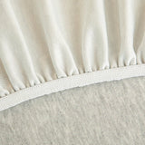 Detail of the elastic hem edge on the silver grey knit stretch sofa cover