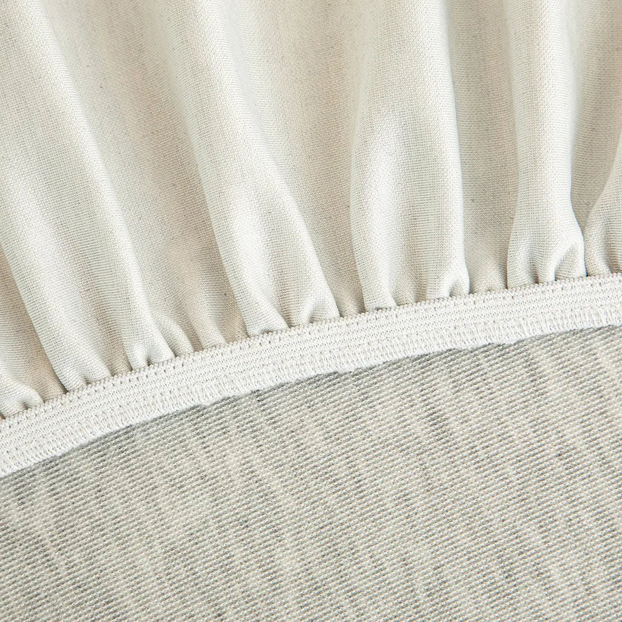 Detail of the elastic hem edge on the silver grey knit stretch sofa cover