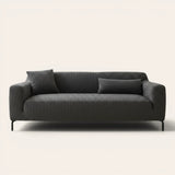Slate charcoal ribbed knit sofa cover fitted on a three-seat couch with cushions, front view on ivory.