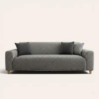 Stone grey knit sofa cover fitted on a three-seat couch with matching cushions, front view on ivory.