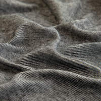 Macro of the stone grey knit texture with fine melange striations draped in soft folds.