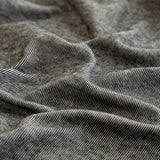 Macro of the stone grey knit texture with fine melange striations draped in soft folds.