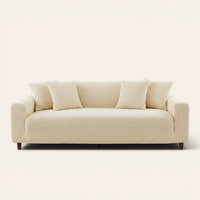 Cream ivory quilted sofa cover fitted on a three-seat couch with matching cushions, front view on ivory.
