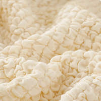 Macro of the cream ivory quilted bubble texture draped in soft folds.