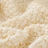 Macro of the cream ivory quilted bubble texture draped in soft folds.