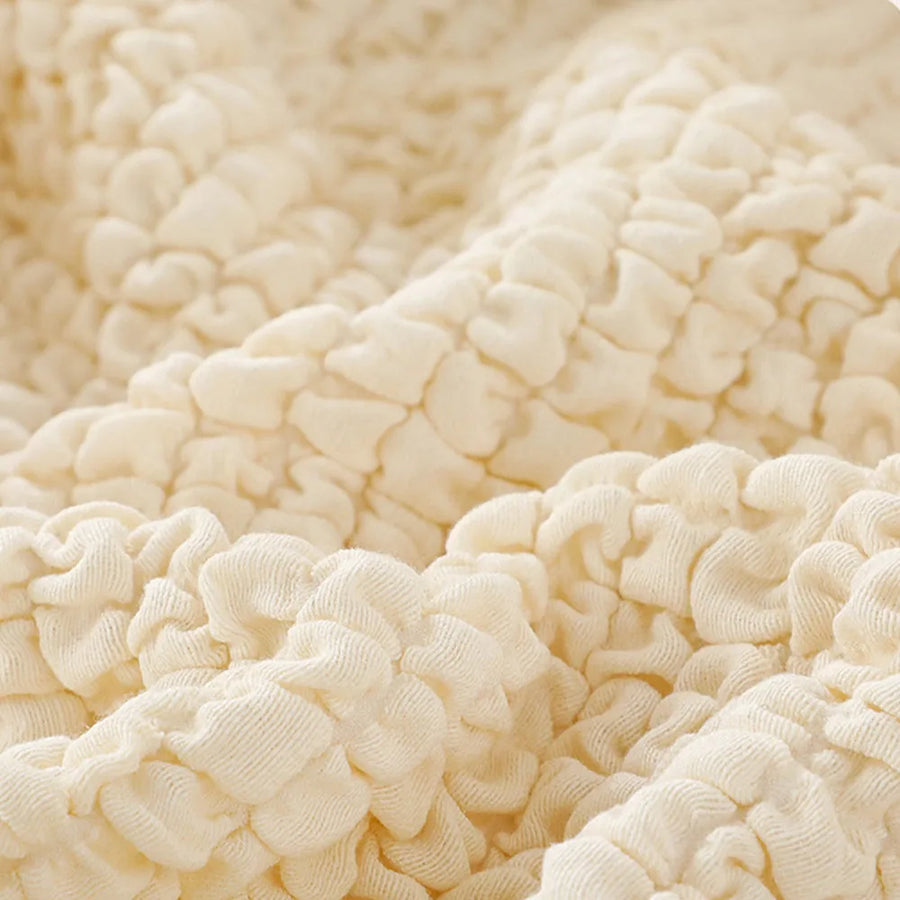 Macro of the cream ivory quilted bubble texture draped in soft folds.