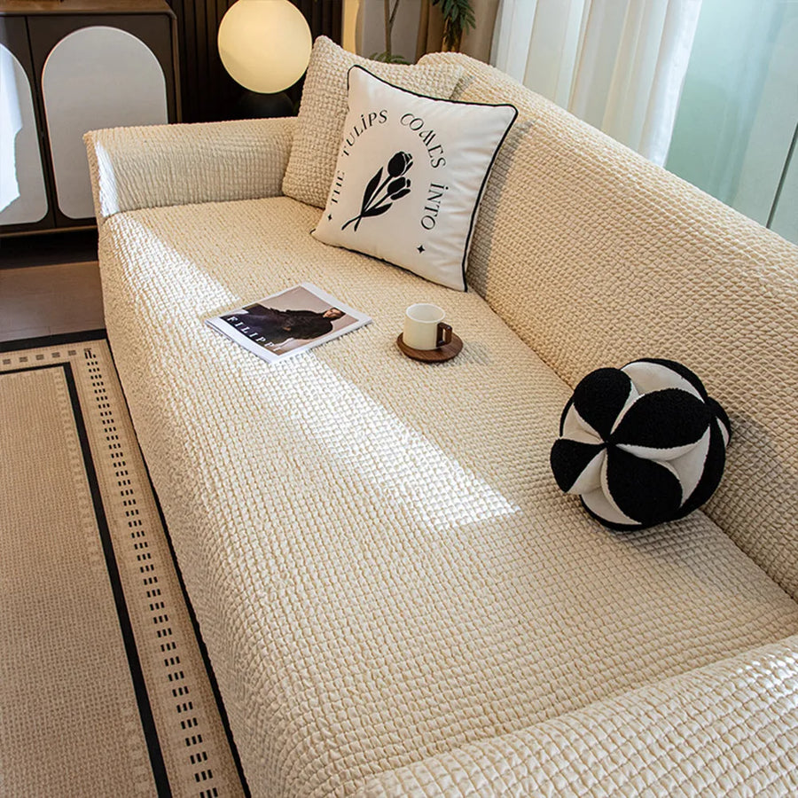 Overhead angle of the cream ivory quilted seat styled with a printed cushion, cup and ball cushion.