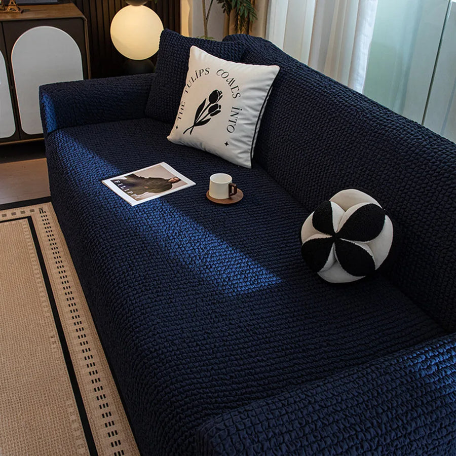 Overhead angle of the midnight navy quilted seat styled with a cushion, book and coffee cup.