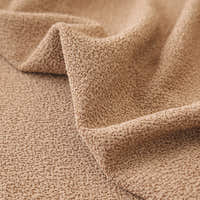 Close-up of the caramel sand smooth microfibre texture draped in a soft diagonal fold.
