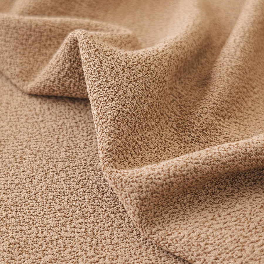 Close-up of the caramel sand smooth microfibre texture draped in a soft diagonal fold.
