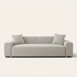 Silver grey smooth sofa cover on a three-seat sofa with matching cushions, front view on ivory