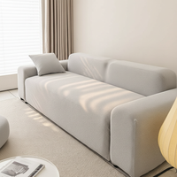 Angled view of the silver grey smooth sofa cover on a sofa in a sunlit living room