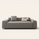 Stone grey smooth sofa cover fitted on a three-seat sofa with matching cushions, front view on ivory